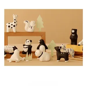 Detail view of cute ceramic animal figurines in a creative forest theater scene