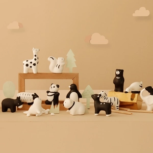 Minimalist monochrome animal figurine set featuring ceramic giraffe, panda and elephant