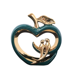 Modern emerald green ceramic apple decor with golden lovebirds and hollow heart design
