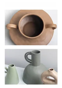 Close-up of matte ceramic vases in Morandi colors with textured finish and various shapes