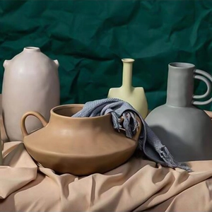 Detail view of matte Morandi ceramic vases with unique shapes and earthy textured finishes