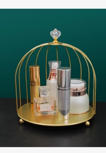 Detailansicht goldener Kosmetik-Organizer im Vogelkäfig-Design mit Kristallgriff