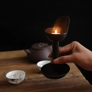 Vintage cast iron candle holder with rustic oil lamp design for home decor