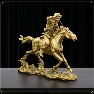 Golden cowboy riding horse statue with metallic finish for luxury home office decor