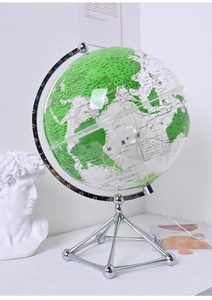 Detailed view of a transparent glowing globe with a silver metal base for desk decor