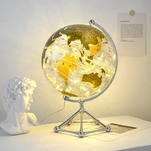 Modern transparent gold world globe with warm LED lights and silver tripod metal base