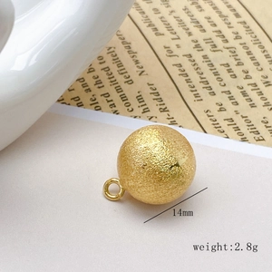 Macro shot of a 14mm brushed gold hollow copper bead pendant for DIY jewelry design