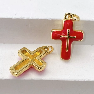 Detailed view of red enamel and gold hollow cross pendants for DIY jewelry making