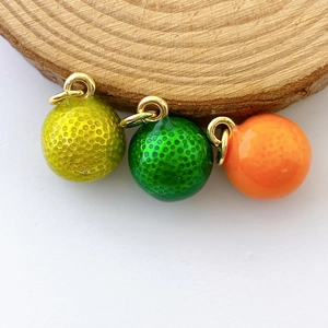 Detail of colorful fruit-style sphere pendants with textured surface and gold ring