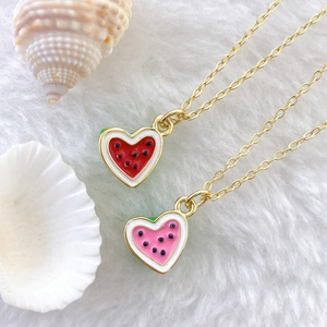 Cute heart-shaped watermelon pendants in red and pink enamel on thin gold chains