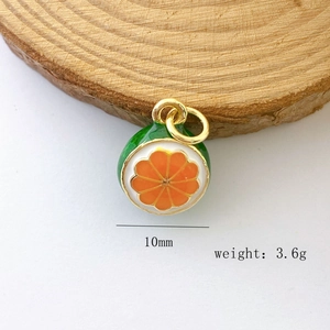 Detail of a 10mm orange fruit pendant with 3.6g weight showing enamel texture