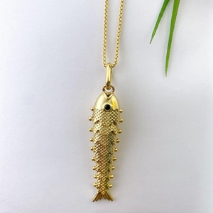 Detailed macro view of the gold-plated koi fish pendant with intricate scale texture