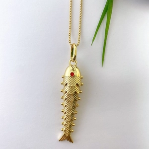 Macro shot of flexible koi carp pendant with gold plating and red crystal eye detail
