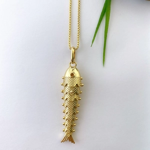 Detailed view of flexible gold-plated koi fish pendant showing scaly texture and segments