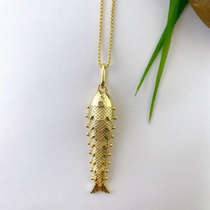 Macro detail of flexible koi fish pendant with intricate gold-plated scale textures