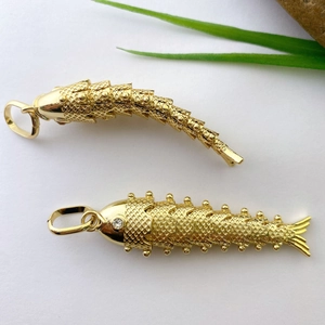 Detailed macro view of gold-plated koi pendants with articulated moving body structure