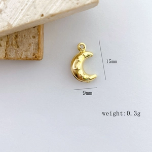 Macro shot of gold crescent moon pendant with star relief detailing and 15mm dimensions