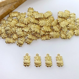 Detailed view of owl-shaped gold charms with textured feathers for DIY jewelry making