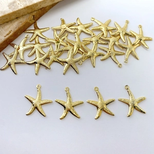 Detailed close-up of golden starfish charms with realistic textured finish and hanging loops