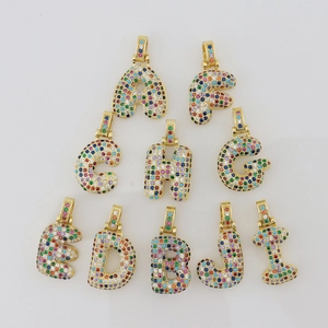 Close-up of gold-plated alphabet pendants A-J with colorful micro-paved cubic zirconia