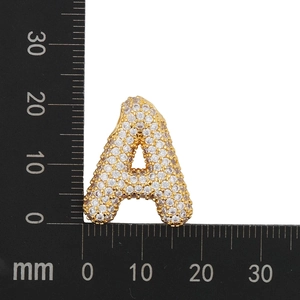 Macro shot of gold-plated letter A pendant with zircon inlay showing 22mm height scale