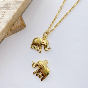 Detailed view of tiny gold-plated elephant pendant charms for DIY jewelry making