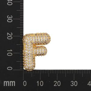 Detailed measurement of gold zircon letter F pendant showing dimensions with a ruler