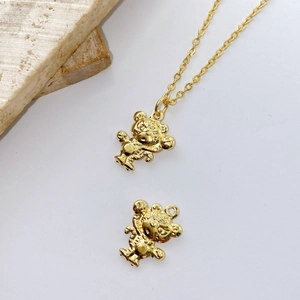 Detail of gold-plated 3D teddy bear pendant charms with textured finish on chain