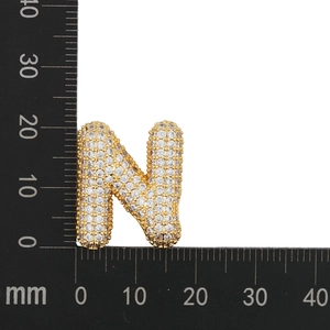 Detail view showing a 25mm gold balloon letter N pendant with white zircon stones