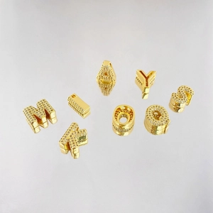 Close-up of gold-plated alphabet pendants micro-pave set with sparkling cubic zirconia