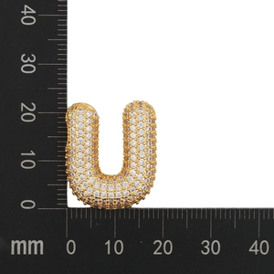 Detailed view of cubic zirconia letter U pendant measuring 18mm on a scale ruler