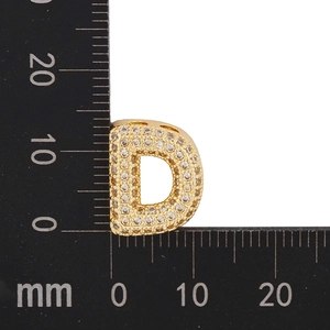 Close-up of gold letter D pendant with cubic zirconia inlay showing size dimensions in mm