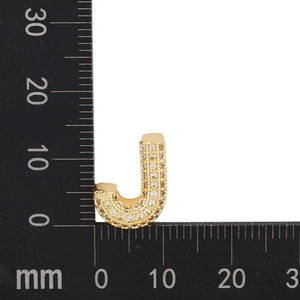 Macro shot of letter J pendant with micro-paved zircons and size measurement scale
