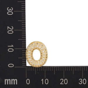 Macro shot of gold zircon letter O pendant measuring 15mm by 12mm on a ruler scale