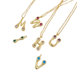 Detailed collection of gold plated letter pendants with colorful zircon stone settings