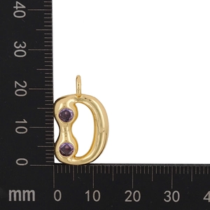 Detail of gold-plated letter D pendant with purple zircon stones and measurement scale