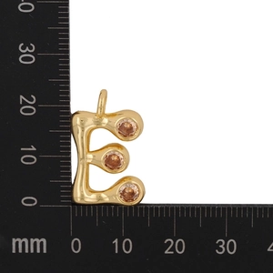 Detailed view of gold letter E pendant with champagne zircons measuring 16mm height