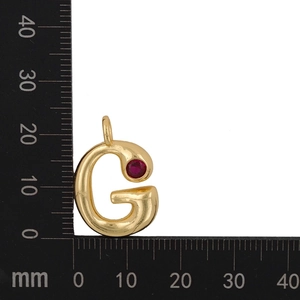 Detailed macro view showing the gold letter G pendant dimensions of 18mm by 15mm with red zircon
