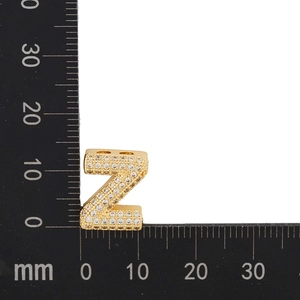 Macro detail of gold plated letter Z pendant with micro-paved cubic zirconia stones