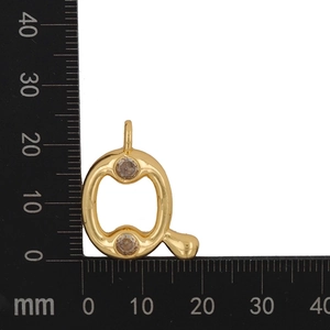 Macro view of gold-plated letter Q pendant with zircon accents and size measurements