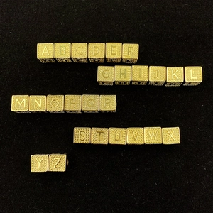 Detailed view of 26 hip-hop style golden square alphabet beads with micro-pave cubic zirconia