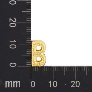 Macro view of gold-plated letter B charm with textured finish and size measurements