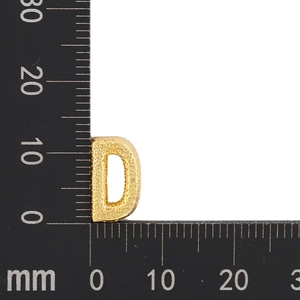 Macro shot of gold-plated letter D charm with texture detail and size measurement