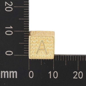 Macro shot of gold cube letter A charm showing 8mm measurement on ruler for DIY jewelry