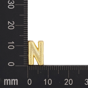 Macro view of gold-plated letter N pendant with hammered texture and 15mm scale measurement