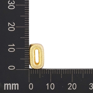 Golden oval spacer bead with dotted texture and 11mm size measurements on a scale