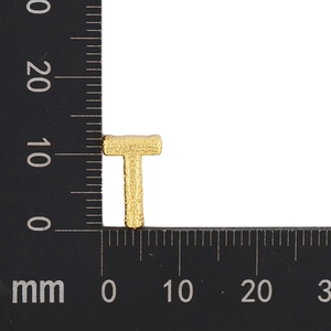 Detail view of gold letter T pendant showing textured surface and 12mm size measurement