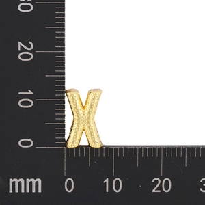 Detailed size measurement of a 12mm gold letter X pendant charm on a black ruler