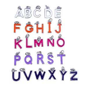Flat lay of 26 colorful enamel alphabet charms for DIY jewelry making sets
