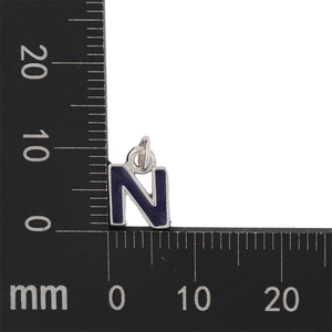 Detailed macro view of blue enamel letter N pendant with precise size measurement scale